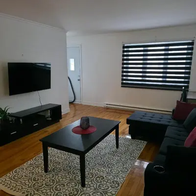 a living room with a couch and a coffee table at Appartement cosy, comme à la maison in Montréal