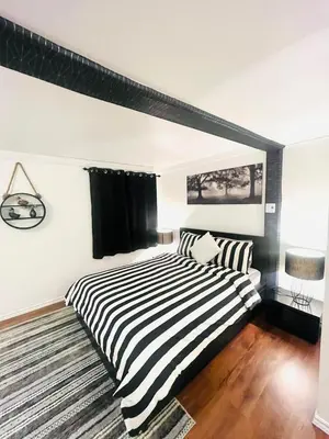 a bedroom with a black and white striped bed at Linda inn - Entire Unit- Sleep 3- Sherbrooke in Sherbrooke