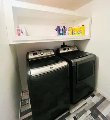 a small kitchen with a black washer and dryer at Linda inn - Entire Unit- Sleep 3- Sherbrooke in Sherbrooke