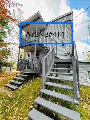 a house with stairs leading up to it at Linda inn - Entire Unit- Sleep 3- Sherbrooke in Sherbrooke