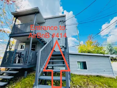 a house with a staircase and a sign on it at Linda inn - Entire Unit- Sleep 3- Sherbrooke in Sherbrooke