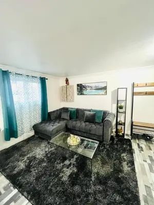 a living room with a couch and a glass table at Linda inn - Entire Unit- Sleep 3- Sherbrooke in Sherbrooke