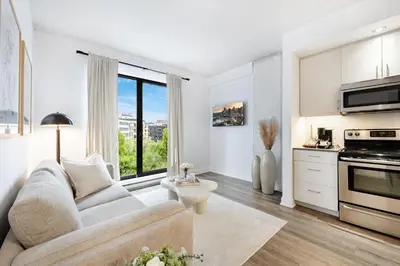 a living room with a couch and a kitchen at La Parisienne in Old Montreal -Downtown Montreal - Laundry in Montréal