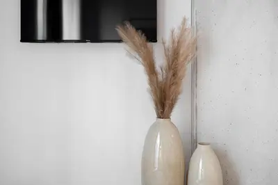 two white vases sitting next to a mirror at La Parisienne in Old Montreal -Downtown Montreal - Laundry in Montréal