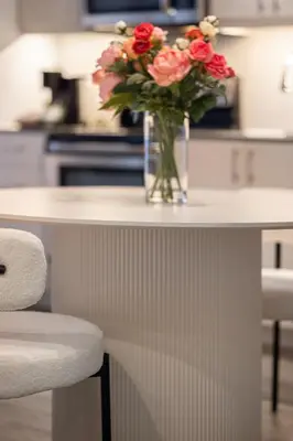a vase of flowers sitting on a counter in a kitchen at La Parisienne in Old Montreal -Downtown Montreal - Laundry in Montréal
