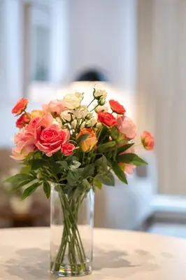 a vase filled with flowers sitting on a table at La Parisienne in Old Montreal -Downtown Montreal - Laundry in Montréal