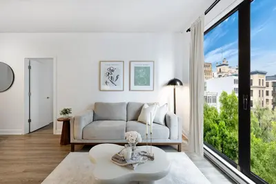 a living room with a couch and a large window at La Parisienne in Old Montreal -Downtown Montreal - Laundry in Montréal