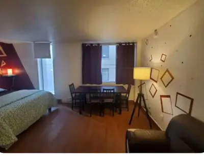 a bedroom with a bed and a dining room table at Studio in Montreal downtown-Free WIFI-Beside metro station Guy-Concordia in Montréal