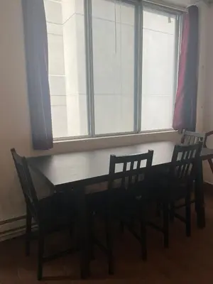 a dining room table with two chairs and a window at Studio in Montreal downtown-Free WIFI-Beside metro station Guy-Concordia in Montréal