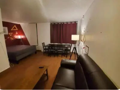 a living room with a couch and a table at Studio in Montreal downtown-Free WIFI-Beside metro station Guy-Concordia in Montréal