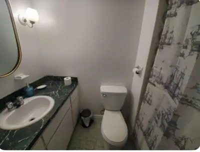 a bathroom with a white toilet and a sink at Studio in Montreal downtown-Free WIFI-Beside metro station Guy-Concordia in Montréal