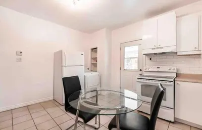 a kitchen with a glass table and white appliances at FULL KITCHEN 14min from DTOWN Room B in Montréal