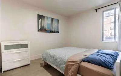 a bedroom with a bed and a dresser and a window at FULL KITCHEN 14min from DTOWN Room B in Montréal