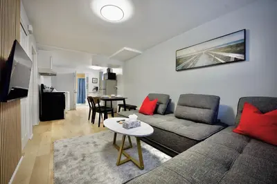 a living room with a couch and a table at Modern, cozy, near Metro, Place Bell, Free Parking in Laval