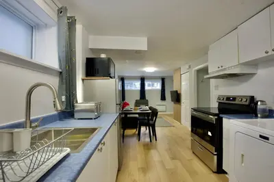 a kitchen with a sink and a counter top at Modern, cozy, near Metro, Place Bell, Free Parking in Laval