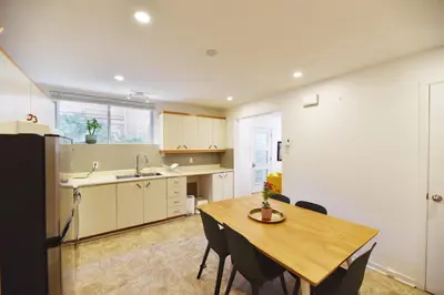 a kitchen with a wooden table and a dining room at Fully equiped flat, great location - ideal for relocation or short term mission in Montréal