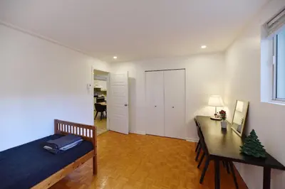 a bedroom with a bed and a desk and a table at Fully equiped flat, great location - ideal for relocation or short term mission in Montréal