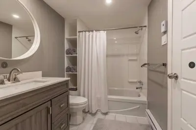 a bathroom with a toilet and a sink and a tub at Fully equiped flat, great location - ideal for relocation or short term mission in Montréal