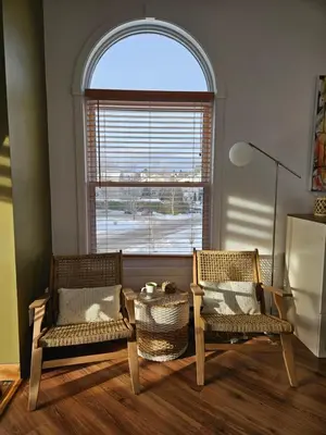 two chairs and a table in a room with a window at Condo ÉVASION in Magog-Orford
