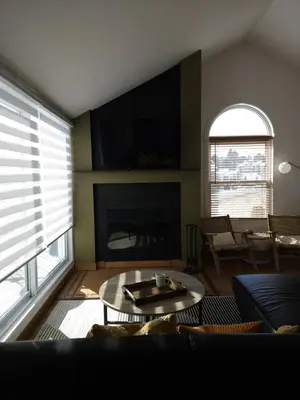 a living room with a couch and a fireplace at Condo ÉVASION in Magog-Orford