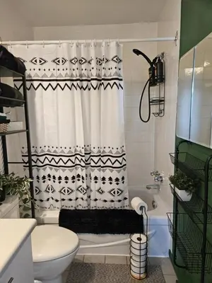 a bathroom with a black and white shower curtain at Condo ÉVASION in Magog-Orford