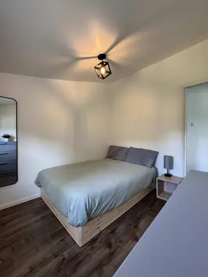 a bedroom with a bed and a ceiling fan at Lake & Game Room - Chalet Brothers and Sun in Disraeli