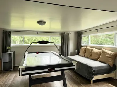 a room with a bed and a pool table in it at Lake & Game Room - Chalet Brothers and Sun in Disraeli