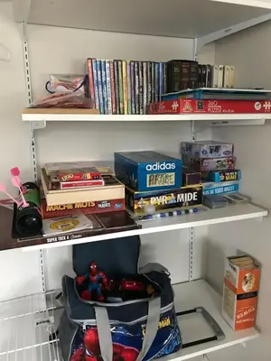 a book shelf filled with books and other items at Lake & Game Room - Chalet Brothers and Sun in Disraeli