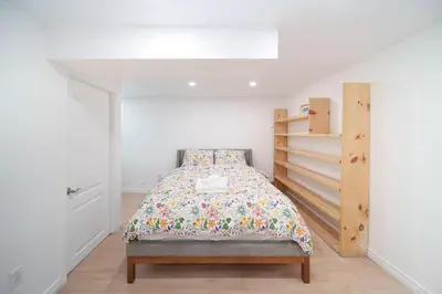 a bedroom with a bed and a book shelf at 4 beds entire house, 15 mins to MTL in Brossard
