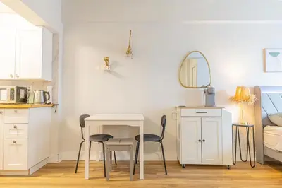 a room with a table and two chairs and a mirror at Studio in heart of DT,walk to 2 metros,Concordia in Montréal