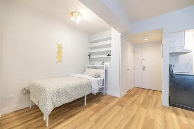 a white bedroom with a bed and a closet at Studio in heart of DT,walk to 2 metros,Concordia in Montréal