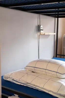 a bunk bed with a pillow on top of it at Auberge Le Treehouse in Montréal