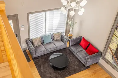 a living room with a couch and a table at Unique Waterfront House 4 BDRs, Near MTL, Fishing in Laprairie