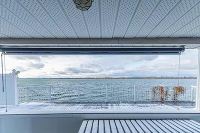 a window with a view of a body of water at Unique Waterfront House 4 BDRs, Near MTL, Fishing in Laprairie