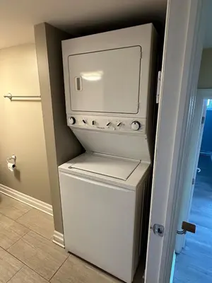 a washer and dryer sitting in a room at Unique Waterfront House 4 BDRs, Near MTL, Fishing in Laprairie