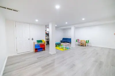 an empty room with colorful tables and chairs in it at Spacious 4BDRS Entire House near DT, Free Parking in Longueuil