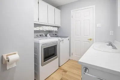 a white laundry room with a washer and a sink at Entire NEW House 5BDR , close to DT MTL, 4 Parking in Brossard