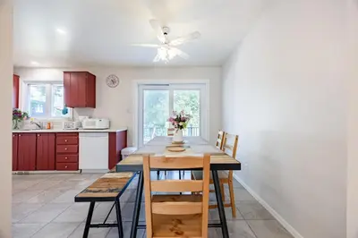 a kitchen with a table and a ceiling fan at Quiet 4 BR House , 20 min to DT, Free Parking in Brossard