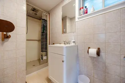 a white bathroom with a sink and a shower at Quiet 4 BR House , 20 min to DT, Free Parking in Brossard