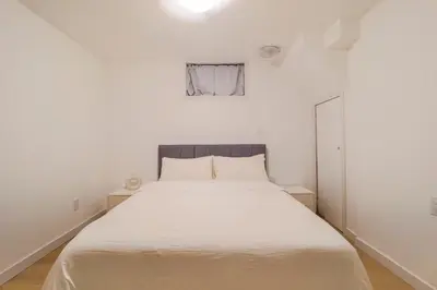 a bedroom with a large white bed in a room at Autumn Fairy Tale, Comfy Entire House with parking in Brossard