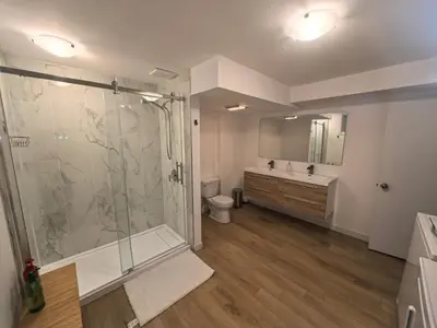 a bathroom with a shower and a toilet and a sink at Autumn Fairy Tale, Comfy Entire House with parking in Brossard