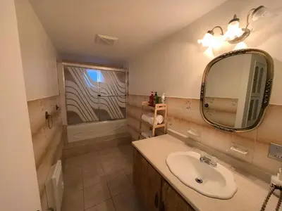 a bathroom with a sink and a mirror at Autumn Fairy Tale, Comfy Entire House with parking in Brossard