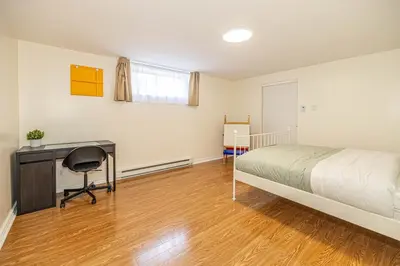 a bedroom with a bed and a desk and a desk at Spacious 2BDRs Apt,ALL NEW! Close to DT , 1 parking in Brossard