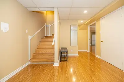 a hallway with stairs and a stool in a room at Spacious 2BDRs Apt,ALL NEW! Close to DT , 1 parking in Brossard