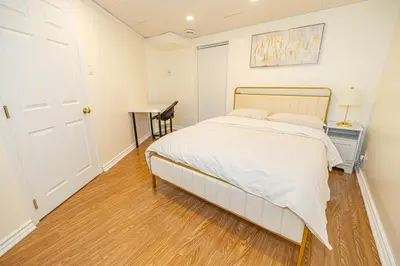 a bedroom with a bed and a desk and a table at Spacious 2BDRs Apt,ALL NEW! Close to DT , 1 parking in Brossard