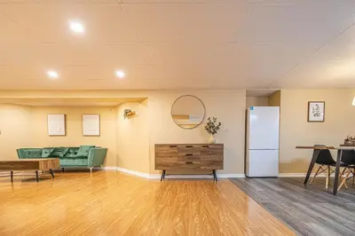 a living room with a couch and a table at Spacious 2BDRs Apt,ALL NEW! Close to DT , 1 parking in Brossard