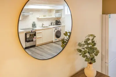 a mirror on a wall with a kitchen at Spacious 2BDRs Apt,ALL NEW! Close to DT , 1 parking in Brossard