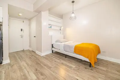 a bedroom with a bed with a yellow blanket on it at Studio in heart of DT,walk to 2 metros,Concordia in Montréal