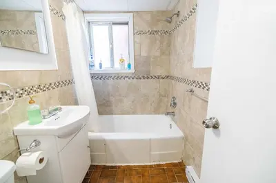 a bathroom with a white tub and a sink at studio in heart of DT, 2 metros, Concordia in Montréal