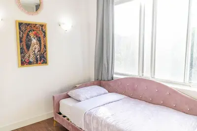 a bed in a room with a large window at 1 BDR at heart of DT, walk to 2 metros, Concordia in Montréal